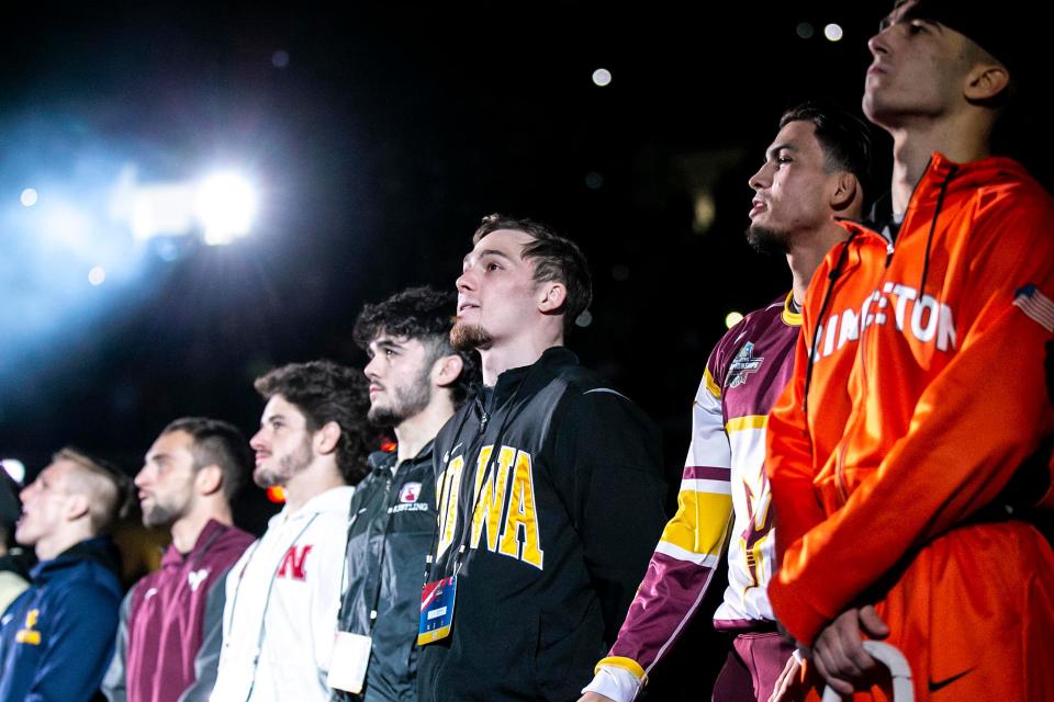 Iowa's Spencer Lee, third from right, stands with 125-pounds All-Americans in the finals during the sixth session of the NCAA Division I Wrestling Championships, Saturday, March 18, 2023, at BOK Center in Tulsa, Okla.