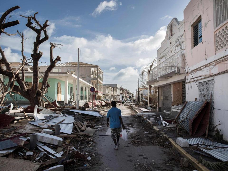 A man walks on a street covered in debris after Hurricane Irma strikes the Saint Martin in the Caribbean in 2017 (AFP/Getty)