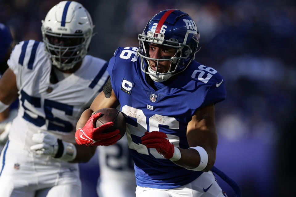 FILE - New York Giants running back Saquon Barkley (26) runs with the ball against the Indianapolis Colts during an NFL football game Jan. 1, 2023, in East Rutherford, N.J. The NFL has filed a grievance against the NFL Players Association, alleging that union leaders, including President JC Tretter, have advised running backs to “consider feigning or exaggerating injuries” to help increase their leverage in contract negotiations. The grievance was filed on Sept. 11, 2023. (AP Photo/Adam Hunger, File)