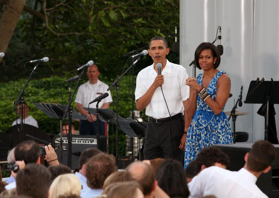President Barack Obama and first lady Michelle Obama host a picnic on the South Lawn. Michelle wears a blue dress she's worn previously.