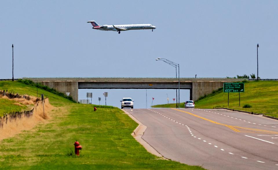 An American Eagle flight flies over SW 54 as it approaches for a landing a Will Rogers World Airport.