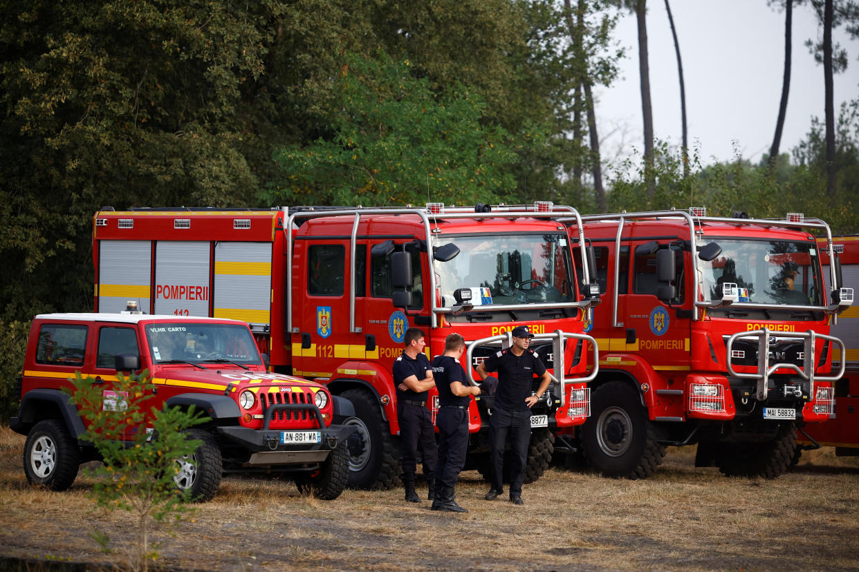 Romanian firefighters arrive at a wildfire command post in Hostens to assist French firefighters, as wildfires continue to spread in the Gironde region of southwestern France, August 12, 2022. REUTERS/Stephane Mahe