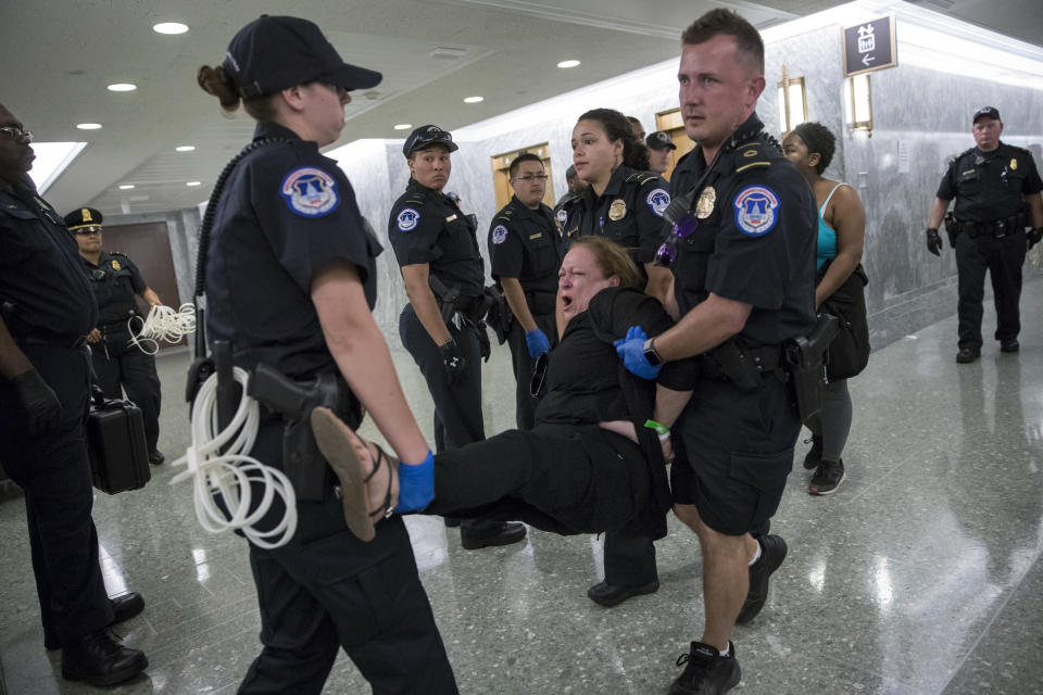 <p>Activists opposed to the GOP’s Graham-Cassidy health care repeal bill, many with disabilities, are removed by U.S. Capitol Police after disrupting a Senate Finance Committee hearing on the last-ditch GOP push to overhaul the nation’s health care system, on Capitol Hill in Washington, Monday, Sept. 25, 2017. (AP Photo/J. Scott Applewhite) </p>