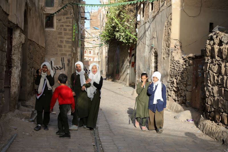 Girls walk in an alley in the old quarter of Sanaa