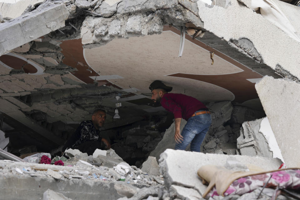 Palestinians inspect the rubble of Islamic Jihad member Anas Al Massri's house after it was hit by an Israeli airstrike last night in Beit Lahiya, northern Gaza Strip, Thursday, May 11, 2023. (AP Photo/Adel Hana)