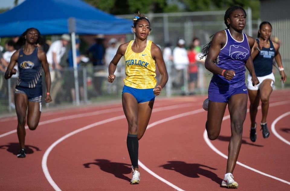 Ihe Okoh of Franklin-EG, right, won a close race over Turlock’s Olivia Walker, middle, in the girls 400 meter race at the CIF Sac-Joaquin Section Masters Track meet at Davis High School in Davis, Calif., Saturday, May 18, 2024. Okoh had a time of 55.38 for first and Walker ran 55.41 for second.