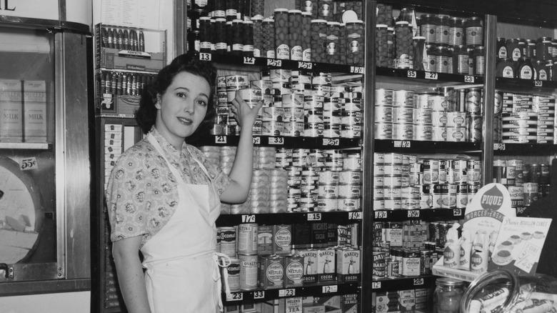 Historical picture of shopkeeper with cans