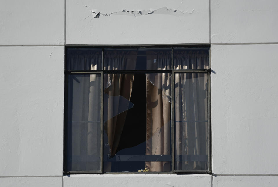 An apartment building window is broken after an overnight earthquake in Ponce, Puerto Rico, Tuesday, Jan. 7, 2020. A 6.4-magnitude earthquake struck Puerto Rico before dawn on Tuesday, killing one man, injuring others and collapsing buildings in the southern part of the island. (AP Photo/Carlos Giusti)