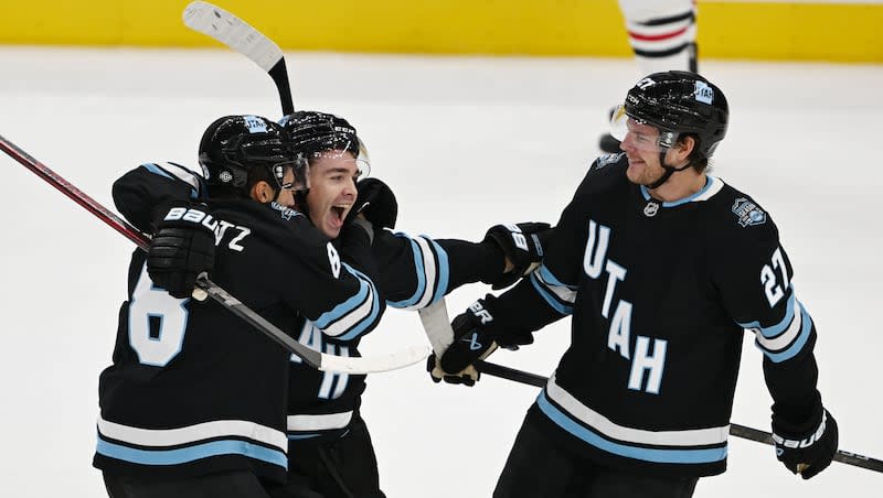 Utah Hockey Club center Clayton Keller (9) celebrates a goal with his teammates, center Nick Schmaltz (8) and center Barrett Hayton (27), as they play in their inaugural game and season opener against the Chicago Blackhawks at the Delta Center in Salt Lake City on Tuesday, Oct. 8, 2024. Utah won 5-2.