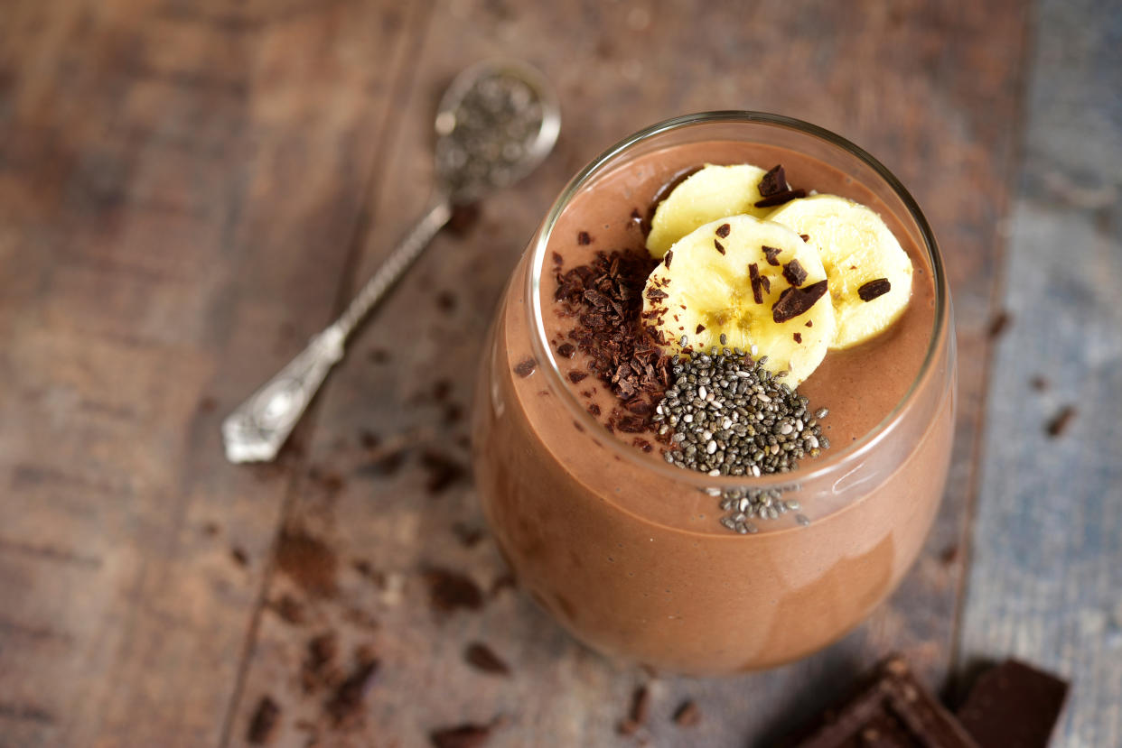 Chocolate banana smoothie with chia seed on a rustic table.