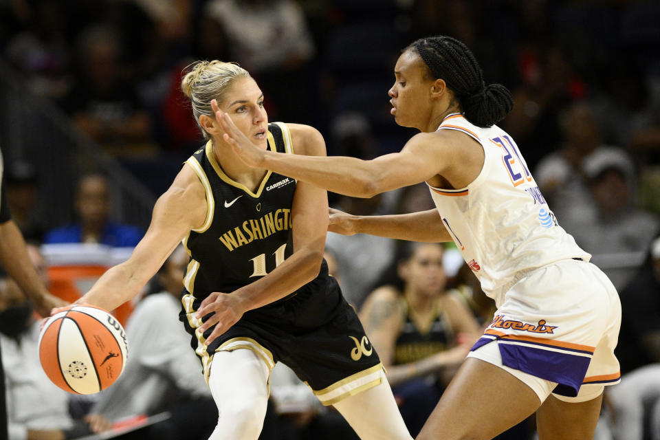 Washington Mystics forward Elena Delle Donne (11) looks to pass the ball as Phoenix Mercury forward Brianna Turner (21) defends during the first half of a WNBA basketball game Friday, June 16, 2023, in Washington. (AP Photo/Nick Wass)