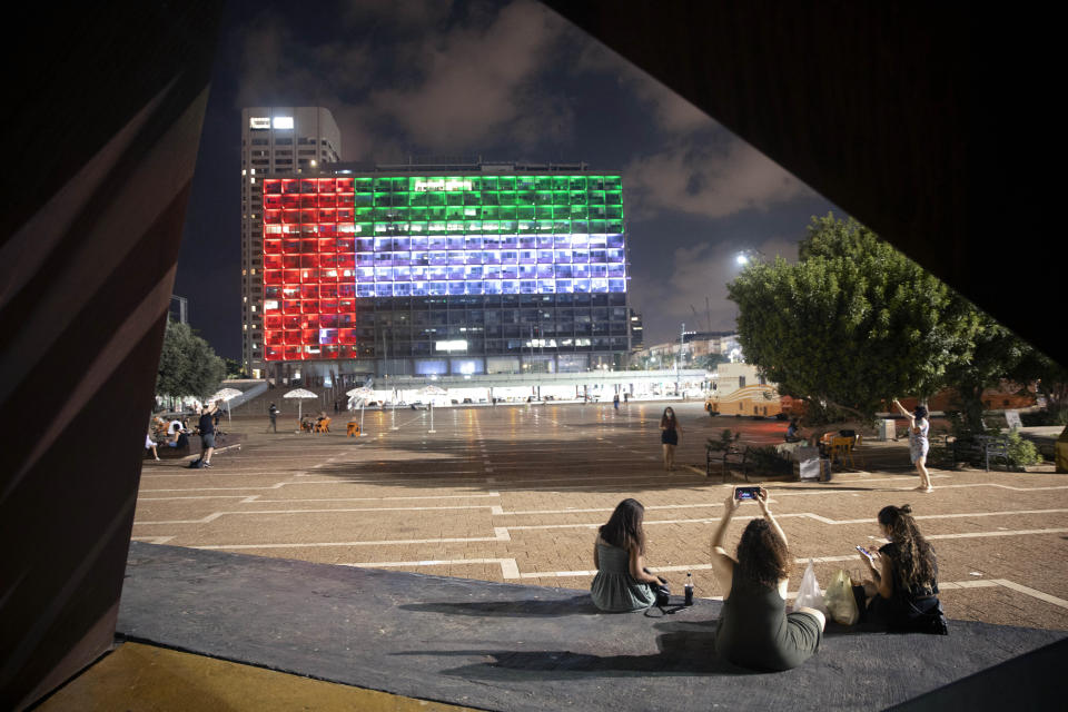 FILE - In this Thursday, Aug. 13, 2020, file photo, the Tel Aviv City Hall is lit up with the flag of the United Arab Emirates as Israel and the UAE announced they would be establishing full diplomatic ties, in Tel Aviv, Israel. Secret talks and quiet ties — that's what paved the way for last week's deal between the United Arab Emirates and Israel to normalize relations. Touted by President Donald Trump as a major Mideast breakthrough, the agreement was in fact the culmination of more than a decade of quiet links rooted in frenzied opposition to Iran that predated Trump and even Barack Obama, as well as Trump's avowed goal to undo his predecessor's Mideast legacy. (AP Photo/Oded Balilty, File)