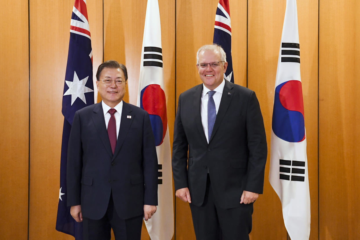 South Korean President Moon Jae-in, left, and Australian Prime Minister Scott Morrison pose for a photo at Parliament House, in Canberra, Australia, Monday, Dec. 13, 2021. Moon is on a two-day official visit to Australia. (Lukas Coch/Pool Photo via AP)