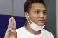 Pyae Lyan Aung, a member of the Myanmar national team who raised a three-finger salute during a qualifying match for the 2022 World Cup in late May, gestures as he arrived at Kansai International Airport in Osaka Prefecture, Japan on Thursday June 17, 2021. Pyae Lyan Aung has refused to return home and is seeking asylum, a request the government was considering taking into account unrest in his country following a coup. (Kyodo News via AP)