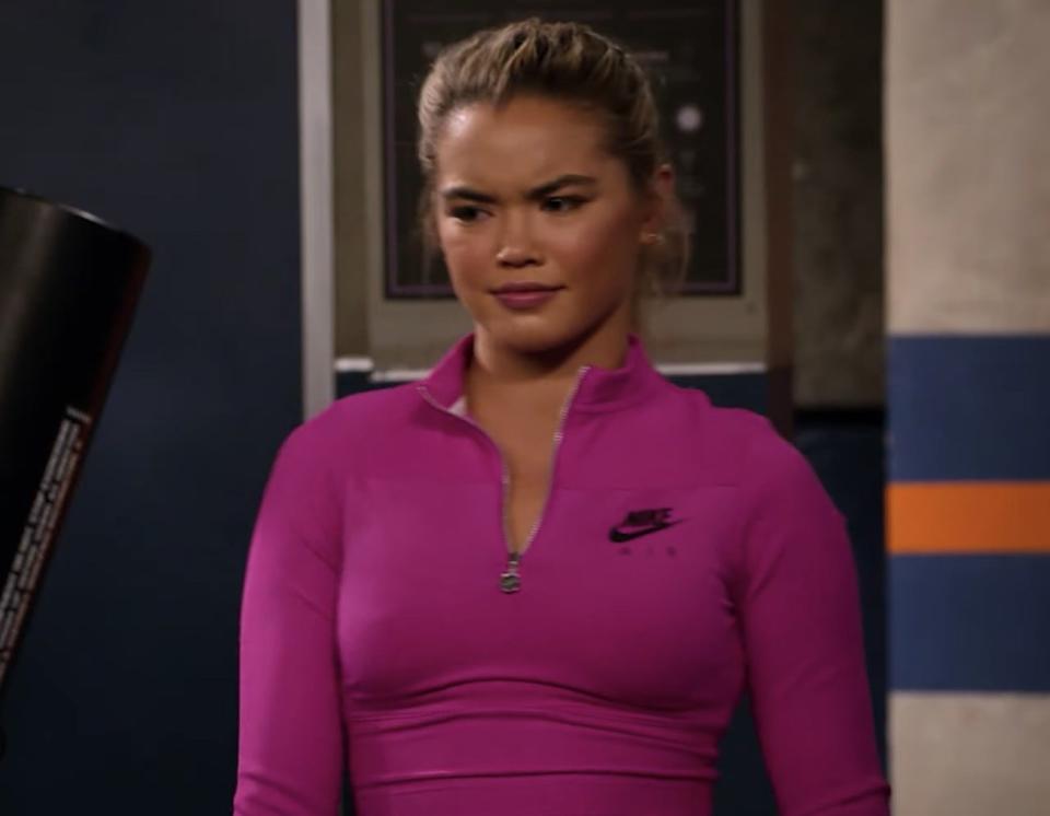 Paris Berelc in a pink sports sweater looking confused.