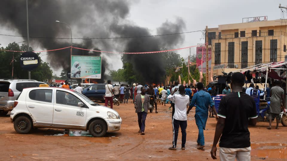 Smoke billows as supporters of the Nigerien defence and security forces attack the headquarters of the Nigerien Party for Democracy and Socialism (PNDS), the party of overthrown President Mohamed Bazoum, in Niamey on July 27, 2023. - AFP/Getty Images