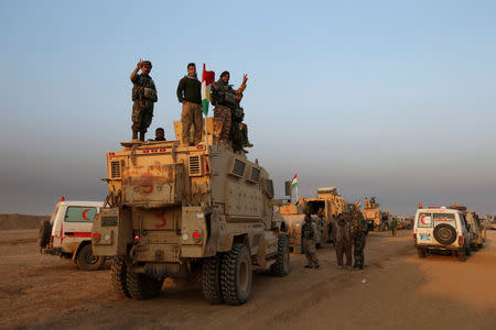 Peshmerga forces stand on a military vehicle in the town of Bashiqa, east of Mosul, during an operation to attack Islamic State militants in Mosul, Iraq, November 7, 2016. REUTERS/Azad Lashkari