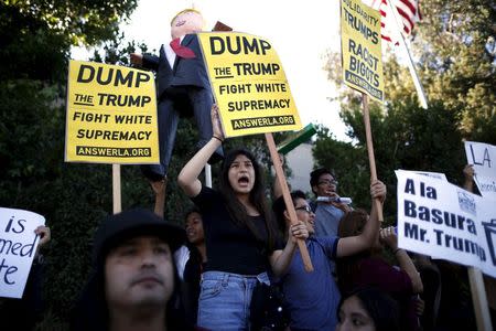 People protest outside the Luxe Hotel, where Republican presidential candidate Donald Trump was expected to speak in Brentwood, Los Angeles, California, United States July 10, 2015. REUTERS/Lucy Nicholson