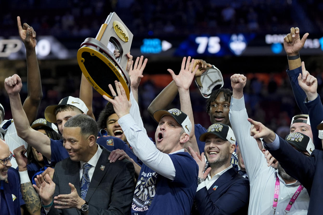 UConn head coach Dan Hurley celebrates with the NCAA championship trophy after their win over Purdue in the title game on Monday in Glendale, Ariz. (AP Photo/David J. Phillip)