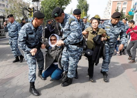 Kazakh law enforcement officers detain women during a rally held by opposition supporters in Nur-Sultan