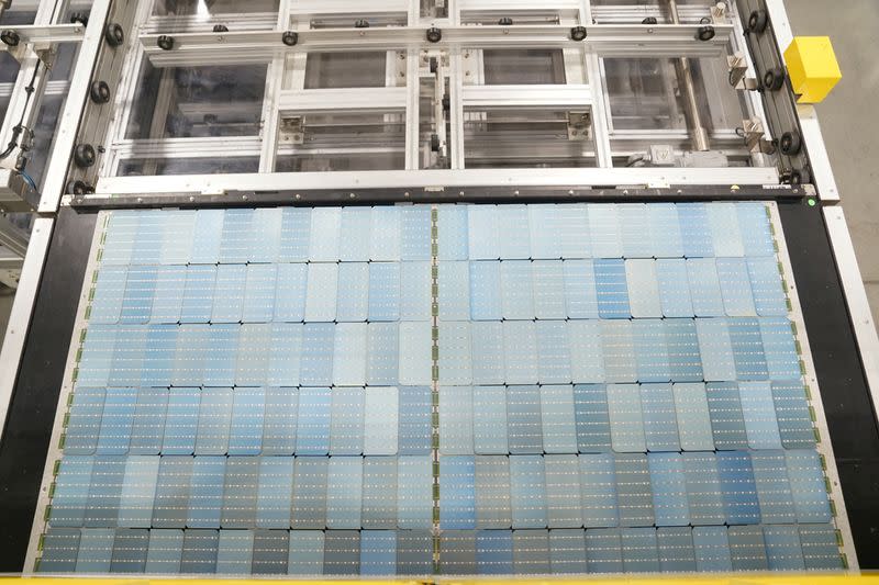 FILE PHOTO: Employees work on solar panels at the QCells solar manufacturing factory in Dalton