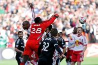 Nov 8, 2014; Washington, DC, USA; D.C. United goalkeeper Bill Hamid (28) punches the ball away from New York Red Bulls defender Jamison Olave (4) in the first half of leg 2 of the Eastern Conference semifinals in the 2014 MLS Cup Playoffs at Robert F. Kennedy Memorial Stadium. Mandatory Credit: Geoff Burke-USA TODAY Sports