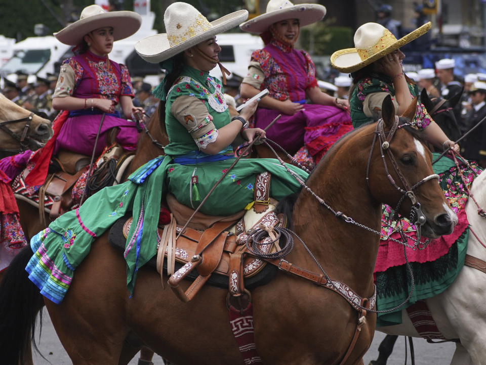 Amazonas dressed as Mexican Revolution-era fighters ride their horses in the annual Independence Day military parade in the capital's main square, the Zocalo, in Mexico City, Friday, Sept. 16, 2022. (AP Photo/Marco Ugarte)