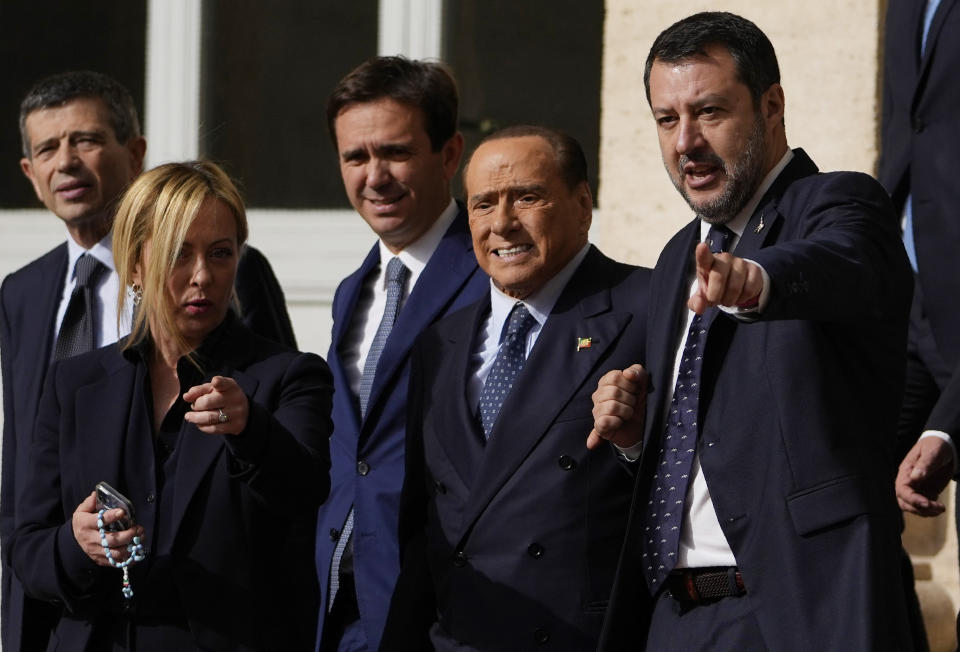 Forza Italia president Silvio Berlusconi, center, poses with Brothers of Italy's leader Giorgia Meloni and The League leader Matteo Salvini, and center-right party members as they leave the Quirinale Presidential Palace after a meeting with Italian President Sergio Mattarella as part of a round of consultations with party leaders to try and form a new government, in Rome, Friday, Oct. 21, 2022. (AP Photo/Alessandra Tarantino)