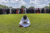 A young boy prays as women line up in prayer during the funeral for the people women killed in a car crash on Lake Street, at the Dar Al-Farooq Islamic Center in Bloomington, Minn., on Monday, June 19, 2023. (Elizabeth Flores/Star Tribune via AP)
