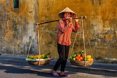 A fruit seller in Hoi An, Vietnam - Credit: GETTY