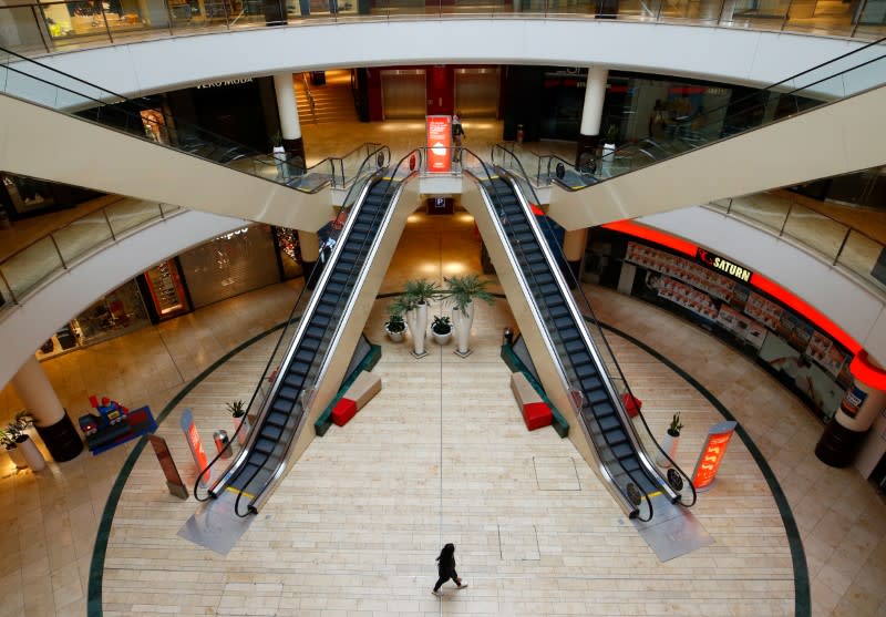 FILE PHOTO: A person is seen inside an empty shopping mall during a partial lockdown in Leverkusen