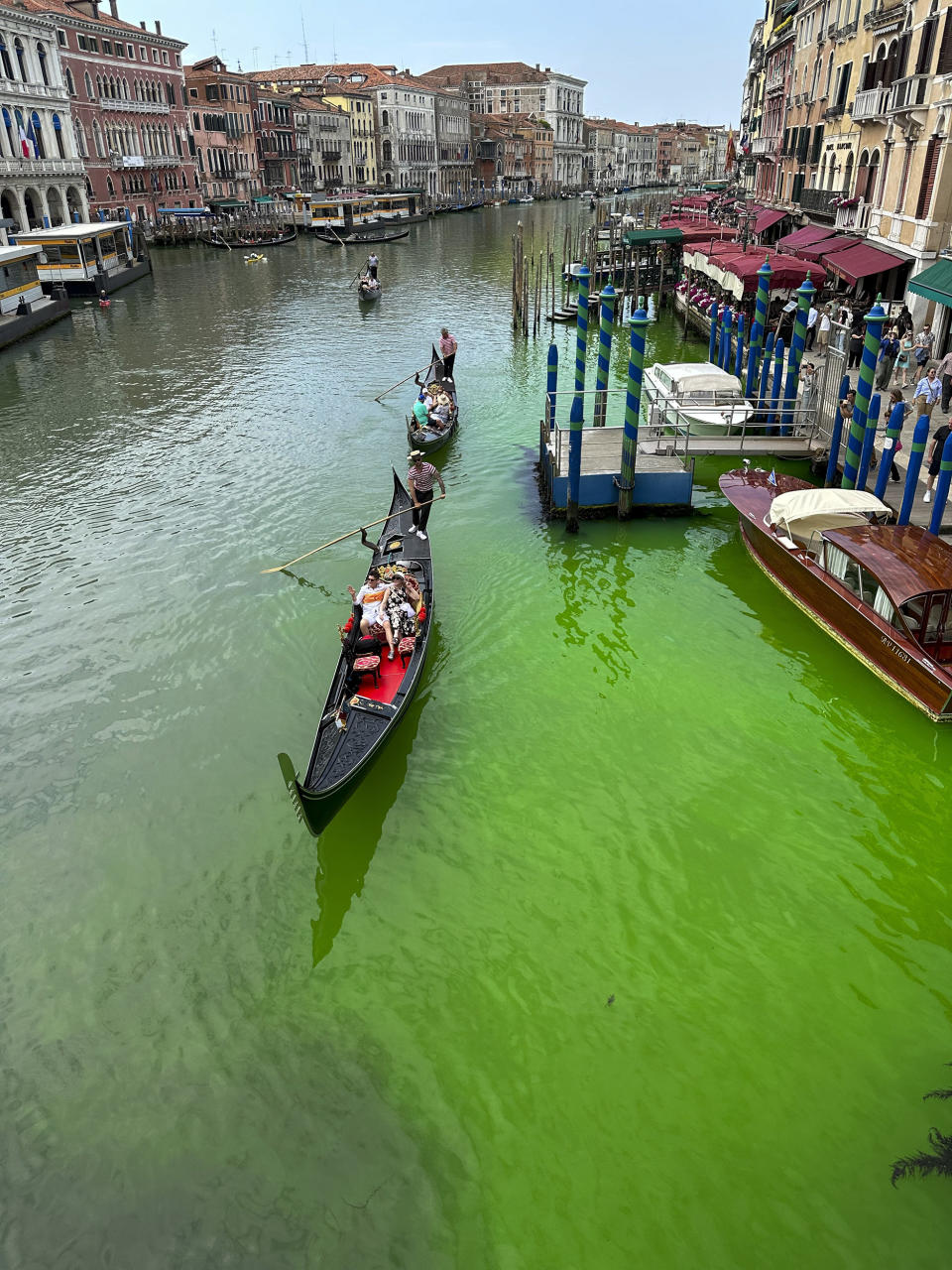 Gondolas navigate by the Rialto Bridge on Venice's historic Grand Canal (Luigii Costantini / AP)