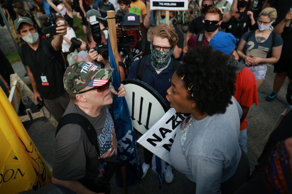 A woman argues with a far-right protester during a rally on August 15, 2020 near the downtown of Stone Mountain, Georgia. Georgia's Stone Mountain Park, which is famous for its large rock carving of Confederate leaders, planned to close on Saturday in response to a planned right-wing rally. / Credit: Getty Images