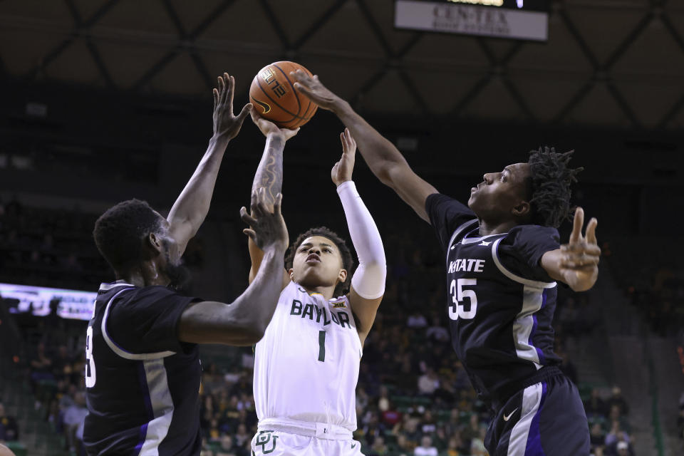 Baylor guard Keyonte George (1) shoots between Kansas State center Abayomi Iyiola, left, and forward Nae'Qwan Tomlin (35) in the first half of an NCAA college basketball game, Saturday, Jan. 7, 2023, in Waco, Texas. (AP Photo/Rod Aydelotte)
