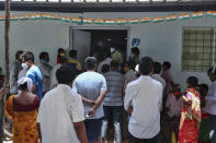 People crowd outside a government hospital to register their names to get vaccinated in Hyderabad, India, Monday, April 19, 2021. India's health system is collapsing under the worst surge in coronavirus infections that it has seen so far. Medical oxygen is scarce. Intensive care units are full. Nearly all ventilators are in use, and the dead are piling up at crematoriums and graveyards. Such tragedies are familiar from surges in other parts of the world — but were largely unknown in India. (AP Photo/Mahesh Kumar A.)