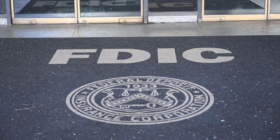 The entrance of a building with the FDIC logo on the floor.