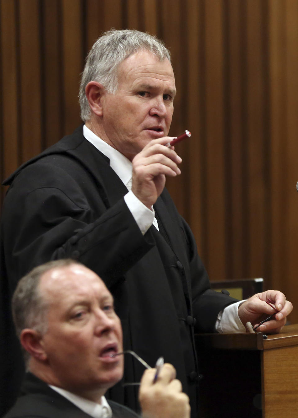 Attorney for Oscar Pistorius, Barry Roux gestures during cross questioning in court during Pistorius' trial at the high court in Pretoria, South Africa, Friday, March 7, 2014. Pistorius is charged with murder for the shooting death of his girlfriend, Steenkamp, on Valentines Day in 2013. (AP Photo/Themba Hadebe, Pool)