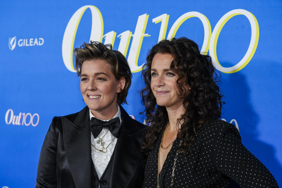 Brandi Carlile and Catherine Shepherd pose for a photo at the Out100 Party in 2023.