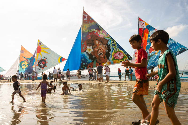 Children play at the beach during the Paraw Regatta festival. The Paraw Regatta Festival is the oldest traditional craft event in Asia, and has a sailboat race as its main event, making it the largest sailing event in the Philippines. Earvin Perias/SOPA Images via ZUMA Press Wire/dpa