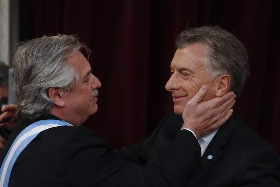 Argentina's new President Alberto Fernandez, left, greets outgoing president Mauricio Macri after receiving from him the presidential sash at the Congress in Buenos Aires, Argentina, Tuesday, Dec. 10, 2019. (AP Photo/Natacha Pisarenko)