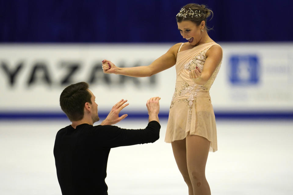 Kirsten Moore-Towers and Michael Marinaro of Canada react after performing in the pairs free skating program during the ISU Grand Prix of Figure Skating in Sapporo, northern Japan, Saturday, Nov. 23, 2019. (AP Photo/Toru Hanai)