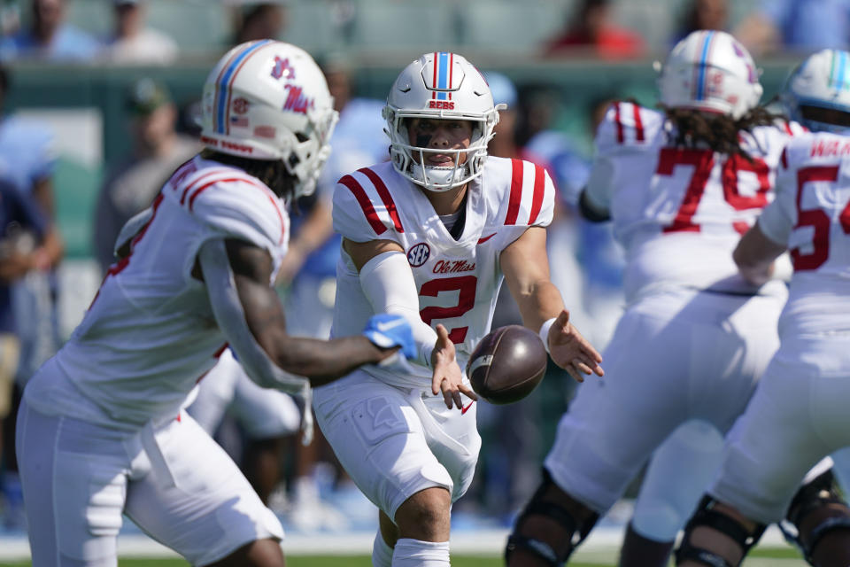 Mississippi quarterback Jaxson Dart (2) pitches out to running back Quinshon Judkins in the first half of an NCAA college football game against Tulane in New Orleans, Saturday, Sept. 9, 2023. (AP Photo/Gerald Herbert)
