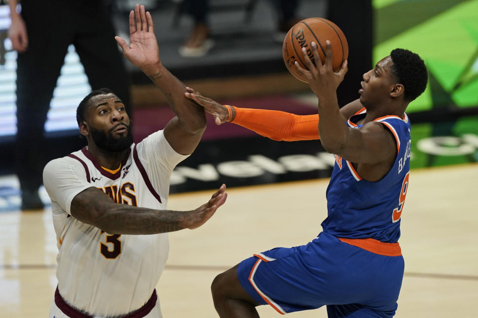 New York Knicks' RJ Barrett (9) drives to the basket against Cleveland Cavaliers' Andre Drummond (3) during the second half of an NBA basketball game, Tuesday, Dec. 29, 2020, in Cleveland. The Knicks won 95-86. (AP Photo/Tony Dejak)