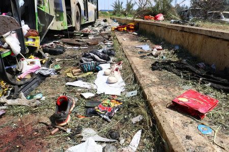 Scattered shoes lie on the ground near damaged buses after an explosion yesterday at insurgent-held al-Rashideen, Aleppo province, Syria April 16, 2017. REUTERS/Ammar Abdullah