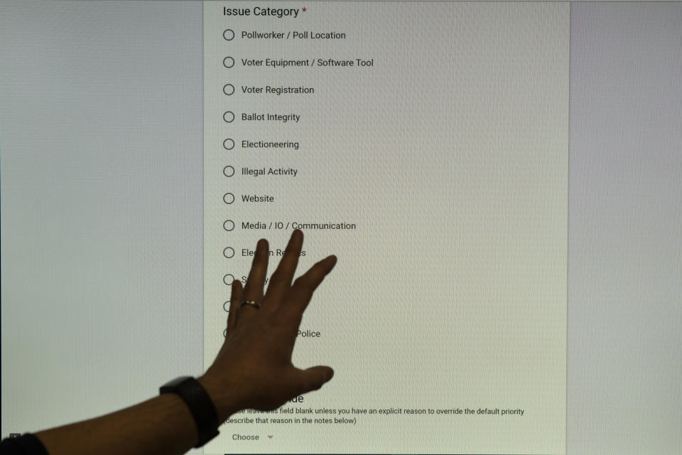 In this Monday, Dec. 16, 2019, photo, a trainer gestures to the screen during an exercise run by military and national security officials, for state and local election officials to simulate different scenarios for the 2020 elections, in Springfield, Va. These government officials are on the front lines of a different kind of high-stakes battlefield, one in which they are helping to defend American democracy by ensuring free and fair elections. (AP Photo/Alex Brandon)