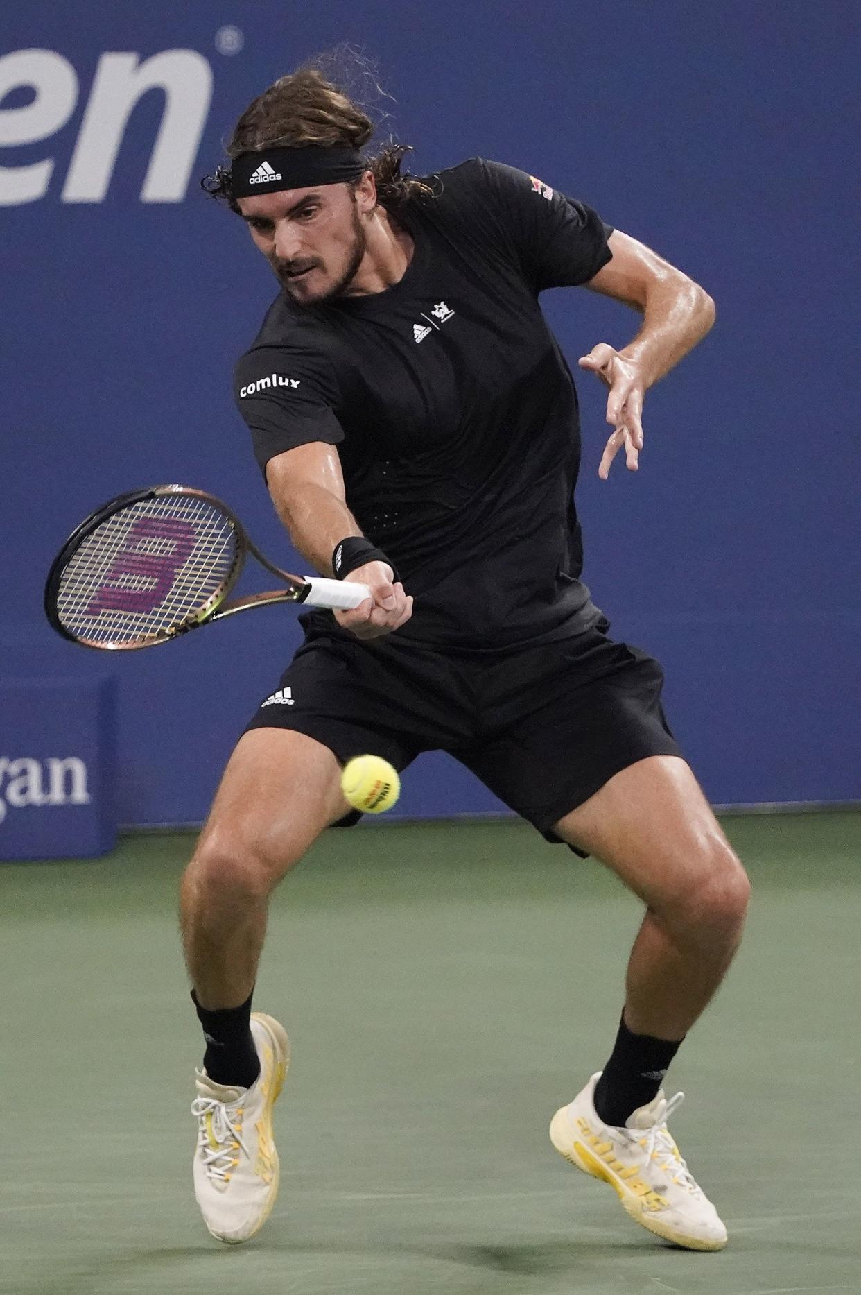 Stefanos Tsitsipas, of Greece, returns a shot to Daniel Elahi Galan, of Colombia, during the first round of the U.S. Open tennis championship on Monday, Aug. 29, 2022, in New York.