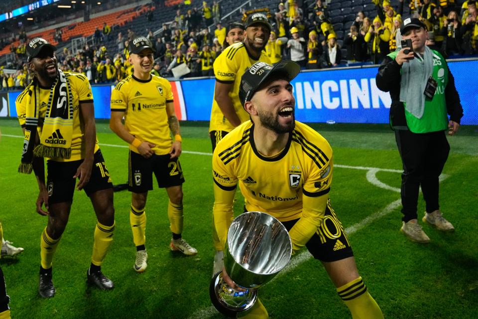 Crew forward Diego Rossi celebrates with the trophy after the 3-2 extra time win over FC Cincinnati in the MLS Cup Eastern Conference Finals.