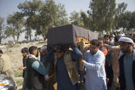 Relatives carry the body of one of three women working for a local radio and TV station who were killed on Tuesday in attacks claimed by the Islamic State group, during her funeral ceremony in Jalalabad, east of Kabul, Afghanistan, Wednesday, March 3, 2021. The coordinated killings were the latest in a bloody campaign against journalists where in just the last six months, 15 journalists have been killed in a series of targeted killings. (AP Photo)