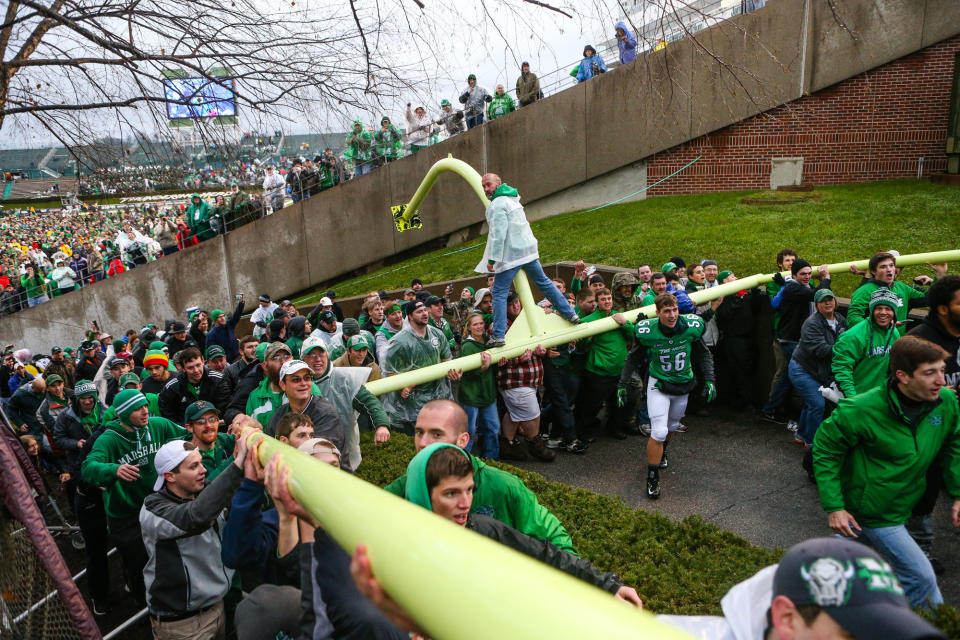 Marshall fans carry the goal post out of Joan C. Edwards Stadium as the Herd defeats Louisiana Tech for the C-USA Championship on Saturday, Dec. 6, 2014, in Huntington, W.Va. Marshall won the C-USA title by a score of 26-23. (AP Photo/The Herald-Dispatch, Sholten Singer)