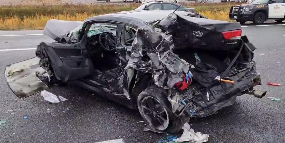 The truck first collided with this black car before crashing into several others, police say.